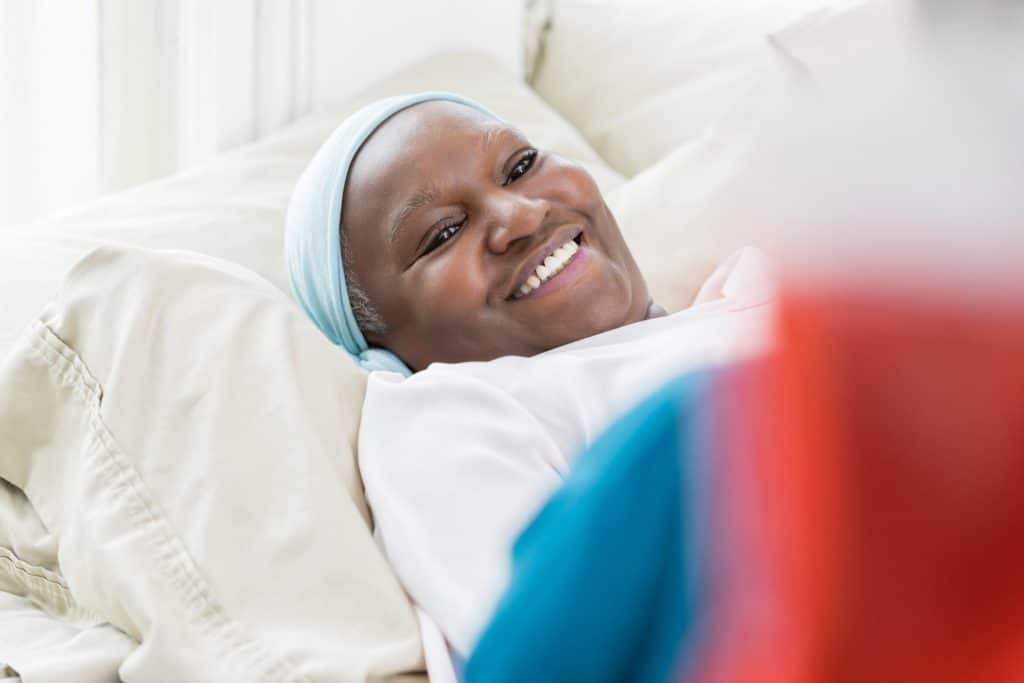 A hospice patient smiling at their caregiver